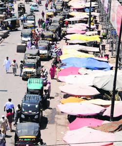 A view of encroachments and stationary auto-rickshaws on the main Jalandhar-Amritsar GT Road near the ISBT in Amritsar
