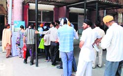 Long queues are seen at the Birth and Death Certificate Department in Amritsar on Thursday