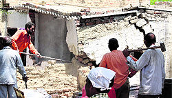 Workers remove encrochments