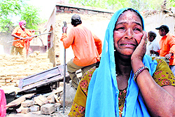 A woman weeps after her house was demolished in the Thandi Sadak area in Bathinda on Thursday