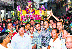 Devotees take part in the Sai Baba palanquin procession in Bathinda on Thursday
