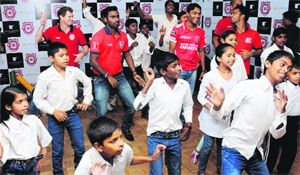 Kings XI Punjab team players dance with underprivileged children from Chhoti Si Asha, an NGO, at a hotel in Sector 35, Chandigarh, on Thursday. 