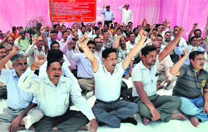 Peyjal Nigam employees protest at the nigams office in Dehradun on Thursday.