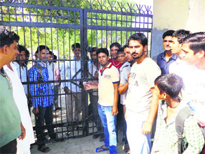 Villagers close the gates of Government High School in Sangroli village of Kaithal on Thursday 