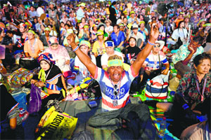 Anti-government protesters raise slogans after Army took control in Bangkok on Thursday