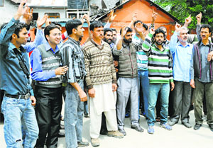 Employees of the Power Development Department stage a protest against the state government in Srinagar on Thursday.