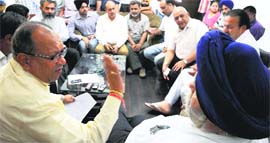 Congress leaders argue with Mayor Harcharan Singh Gohalwaria at Zone-D office in Ludhiana on Thursday.