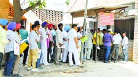Residents await their turn in a long queue at the Civil Surgeons Office in Ludhiana.