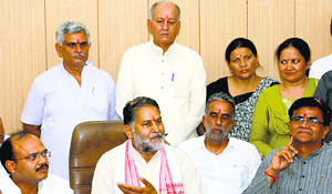 State BJP chief Ram Bilas Sharma (left) addresses a press conference in Rohtak on Friday.