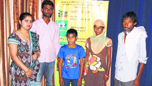 Sandeep with his parents, Child Line coordinator Mamta Kathuria and another member of the helpline service in Sirsa on Friday.