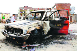 A vehicle burnt by residents of Nathupur village of Gurgaon in protest against the move to demolish a house on Friday. 