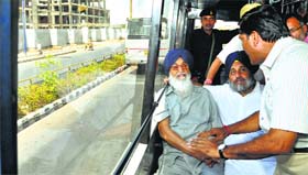 Chief Minister Parkash Singh Badal and Deputy CM Sukhbir Badal review the Bus Rapid Transport System in Ahmedabad on Friday.