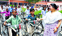Education Minister Geeta Bhukkal distributes cycles among students in Jhajjar on Saturday
