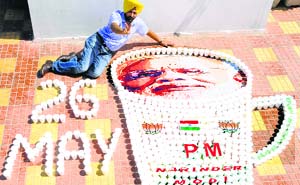Artist Harwinder Singh Gill creates an oversized tea cup with PM-designate Narendra Modi's picture and his swearing-in date in Amritsar on Saturday.