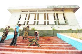 Somali soldiers prepare to carry the body of their colleague who was killed during a fight with Al Shabaab militia outside Parliament in Mogadishu on Saturday.