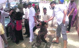 The three women being beaten up by the crowd at 60-Feet Road in Bathinda on Sunday. photos by writer