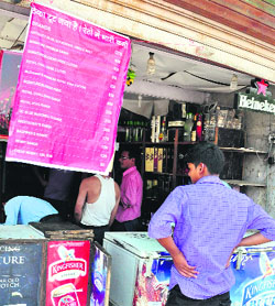 A banner, announcing a discount on liquor brands, outside a shop in Attawa village in Sector 42, Chandigarh. 