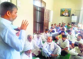 An inmates speaks to a police officer at the Dabwali Kusht Ashram on Sunday