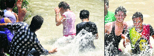 As the mercury soar to 39 Celsius on Sunday, locals visit the Ranvir Canal in Jammu to get some respite from the scorching heat. 