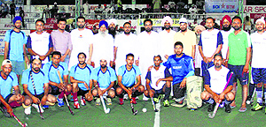 Players with the chief guest during the hockey festival at Jarkhar on Sunday