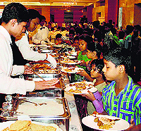 Children of an orphanage having lunch organised by a Modi supporter ahead of his oath ceremony at a five star hotel in Surat on Sunday