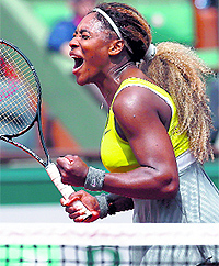 Serena Williams celebrates her victory against Alize Lim in the first round of the French Open in Paris on Sunday
