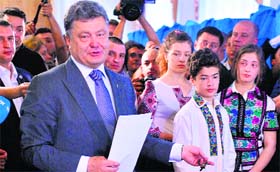 Ukrainian presidential candidate Petro Poroshenko goes to cast his ballot at a polling station in Kiev on Sunday.