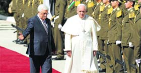 Pope Francis and Palestinian president Mahmud Abbas (left) arrive at the presidential palace in Bethlehem on Sunday.