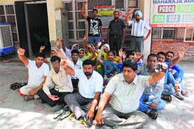 Rural health workers stage a dharna at the Zila Parishad office in Bathinda on Monday