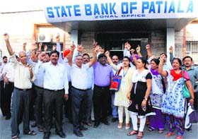 Employees of the State Bank of Patiala protest outside the zonal office in Bathinda on Monday