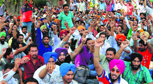 Employees of the 108 Ambulance Employees Association, Punjab, protest at the Civil Hospital in Mohali on Monday.