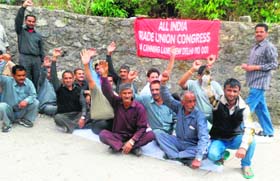 Members of trade unions under the banner of All India Trade Union Congress stage a protest in Mussoorie on Monday.
