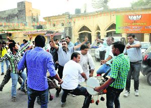 BJP workers dance to drum beats to celebrate Narendra Modis swearing-in as Prime Minister, outside the party office in Jammu on Monday.