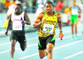Jamaicas Yohan Blake (R) wins the mens 4x100 metres relay during the IAAF World Relays Championships