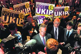 UK Independence Party leader Nigel Farage (C) talks to the media in Southampton on Monday