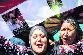 Pro-military fervour in Egypt: Supporters of ex-army chief Abdel Fattah al-Sisi (portrait) celebrate after voting in front of a polling station in Cairo on Monday