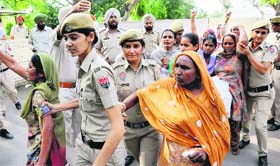 Agitating victims family members being taken by the police from outside the IGs residence in Bathinda on Tuesday.