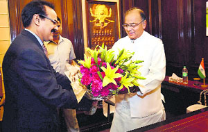 Finance Secretary Arvind Mayaram presents a bouquet to Arun Jaitley as he takes charge as Finance Minister in New Delhi on Tuesday.