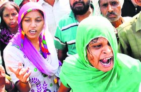 Rajnis family members block traffic and protest on the Karnal-Kaithal road on Tuesday