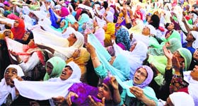 Devotees pray as they have a glimpse of the holy relic of Prophet Mohammed during Meraj-ul-Alam celebrations at the Hazratbal shrine in Srinagar on Tuesday.