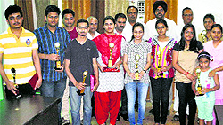 Students strike a pose with prizes after the declaration of CBSE Class XII results in Bathinda on Wednesday