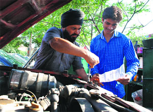 Parbinder Singh with his father at the Motor Market in Mani Majra on Wednesday.