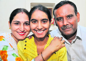Meenakshi in a jubilant mood with her parents at their residence in Sector 23, Chandigarh, on Wednesday.