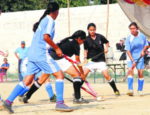 Players in action in a match in the six-a-side girls hockey super league played at Parade Ground in Dehradun on Wednesday.