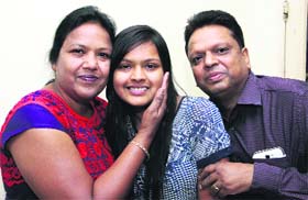 Surbhi Bansal, commerce topper, with her parents in Jalandhar on Wednesday