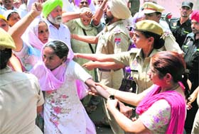 A woman being taken into custody during an agitation outside the IGP office in Bathinda on Thursday