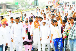 BJP Kisan Morcha national president Om Prakash Dhankar (garlanded) on the second day of his padyatra in Dujana village of Jhajjar district on Thursday. 