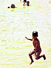 Children bathe in a pond at Jhiri village in Jammu