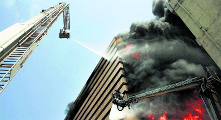 Firefighters try to control flames in the Orchid Vipul multi-storeyed building in Surat on Thursday.