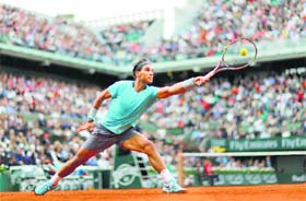 Nadal stretches out to hit a return to Dominic Thiem during their second round match at the French Open in Paris on Thursday